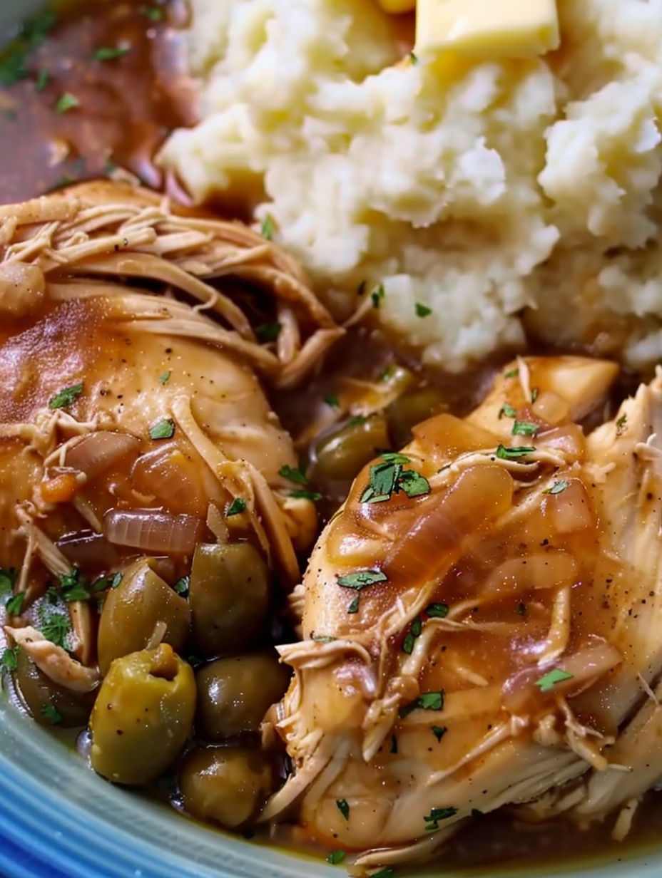 A plate of Mississippi chicken with green beans and mashed potatoes.