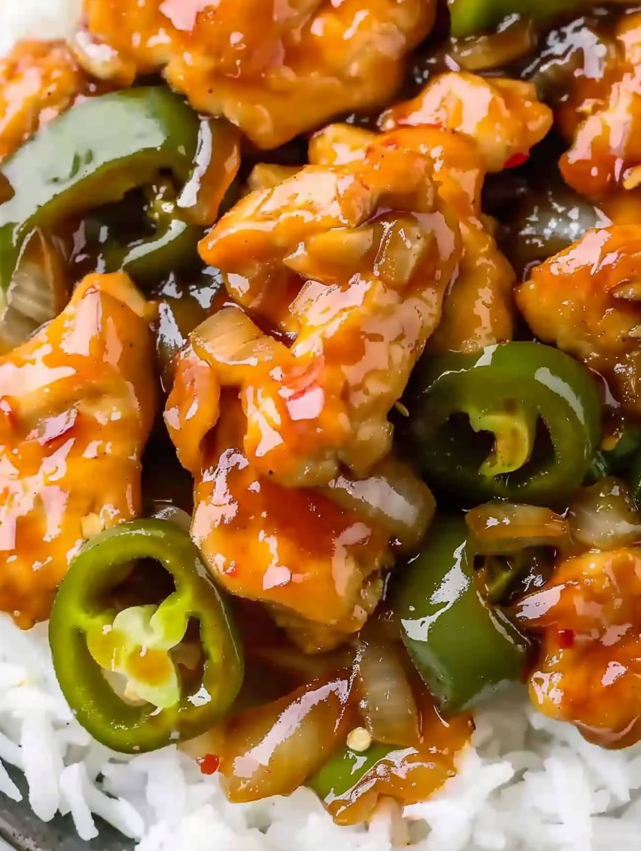 A plate of jalapeno chicken with sauce.