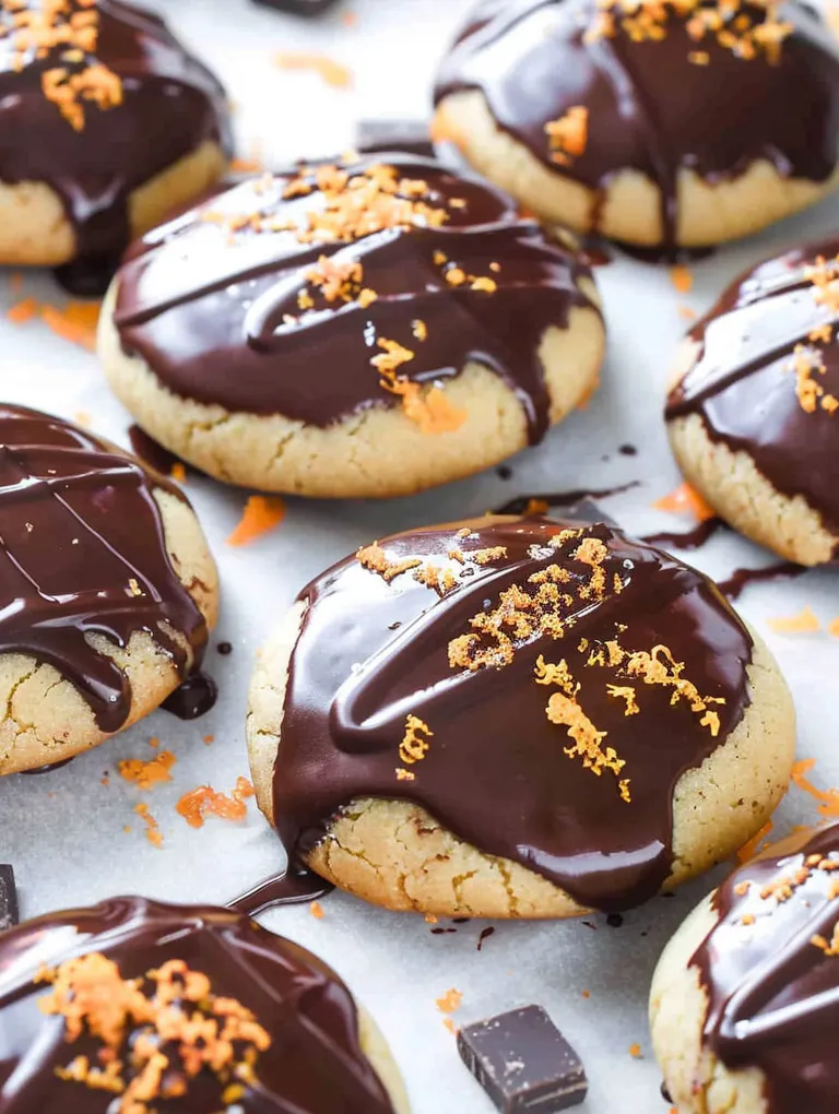 Chocolate chip cookie with orange sprinkles.