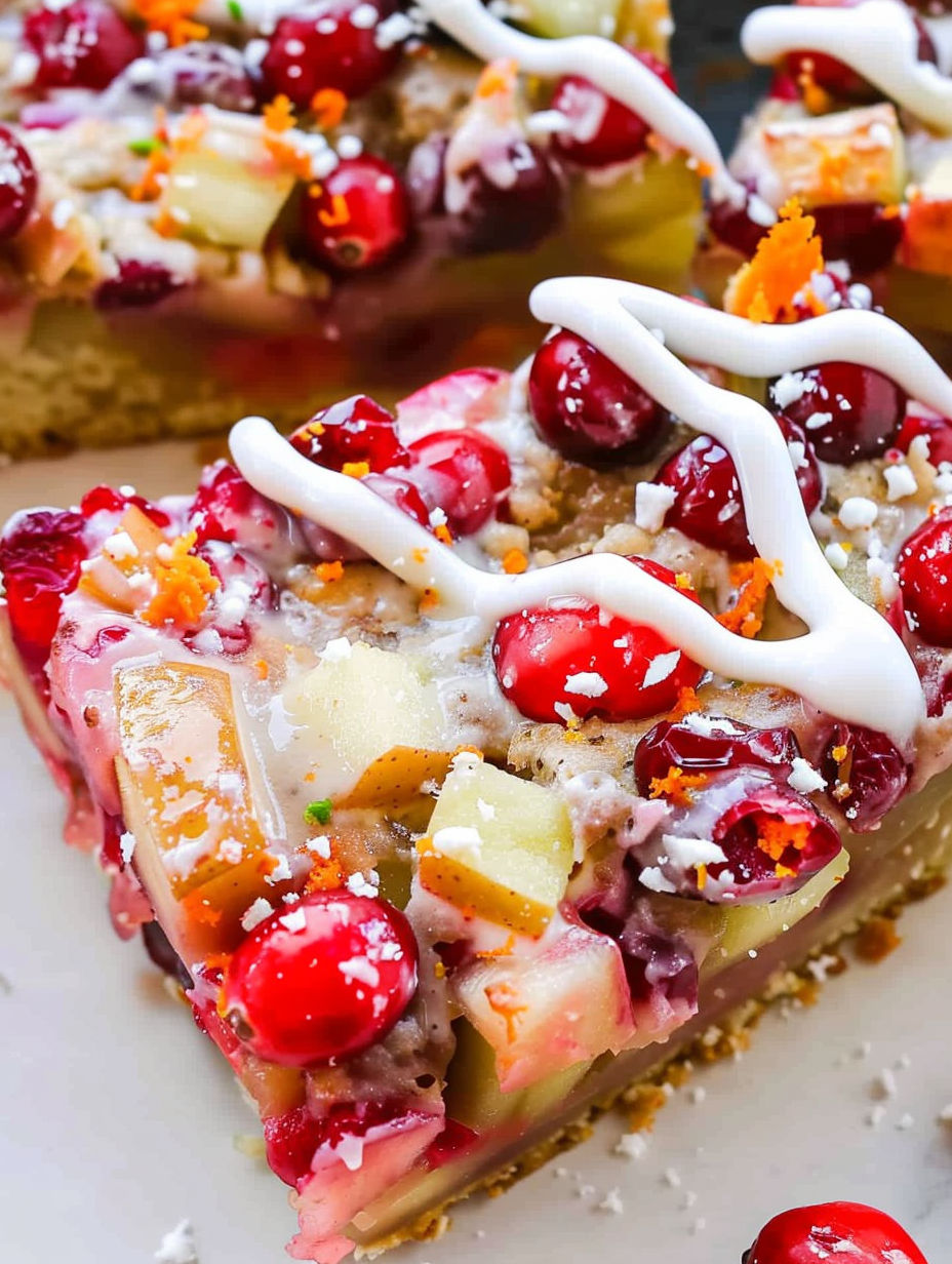 A slice of cake with white icing and red cranberries.