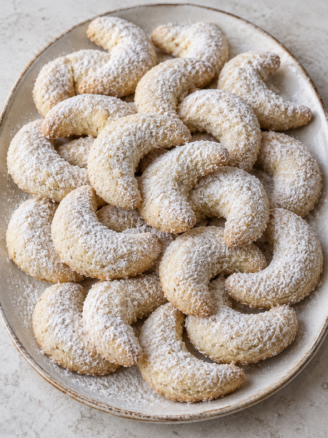Traditionelle Vanillekipferl mit Puderzucker im Hochformat