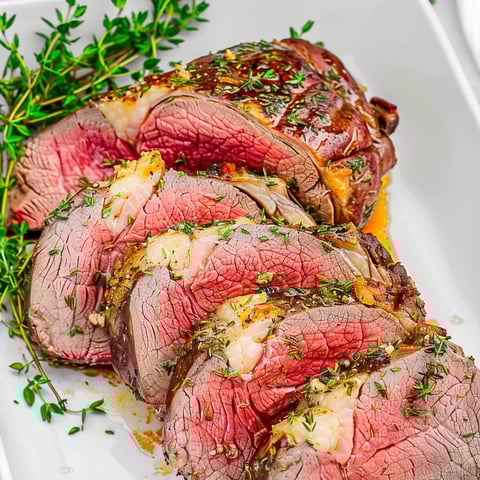 A roast of beef with garlic herb butter.