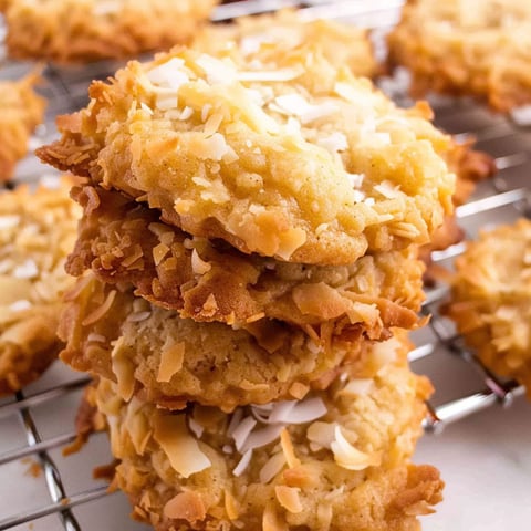 A stack of coconut cookies on a wire rack.