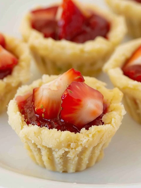 A pastry with strawberries and cream cheese.