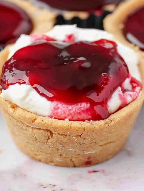 A small dessert with a cherry on top.