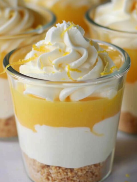 A glass of lemon parfait with whipped cream.