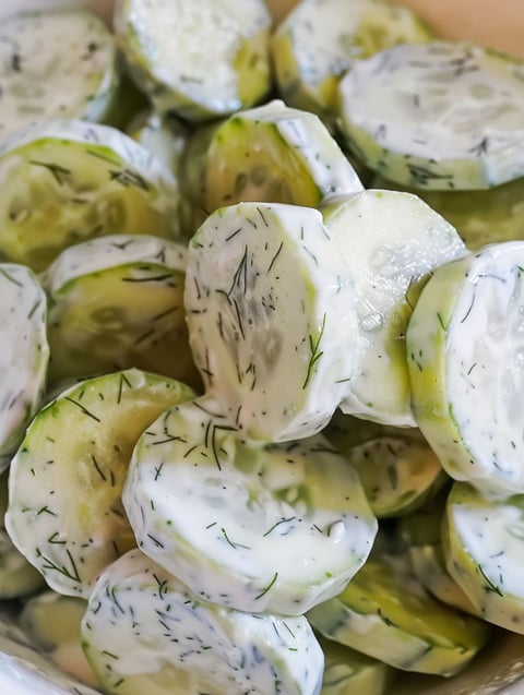 Creamy cucumber salad with cucumber slices.