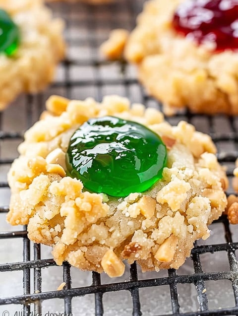 A thumbprint cookie with a green jelly center.