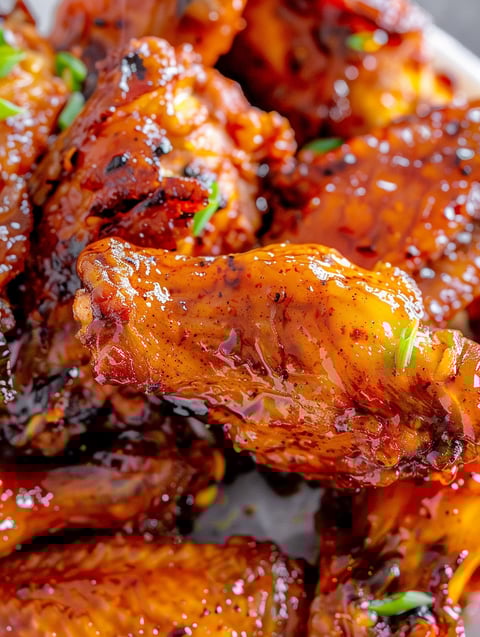 A close up of some delicious looking hot honey peach wings.