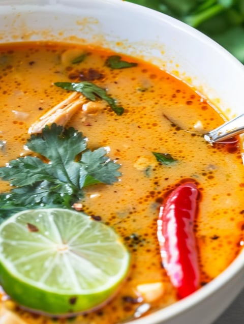 A bowl of soup with a spoon in it.