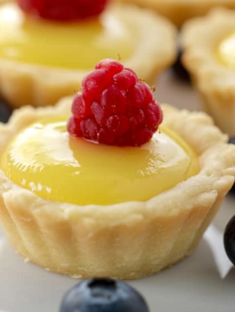 A small pastry with a raspberry on top.