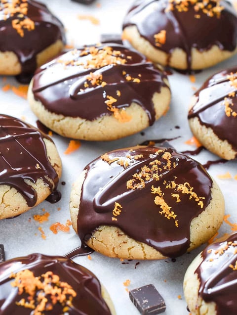 Chocolate chip cookie with orange sprinkles.