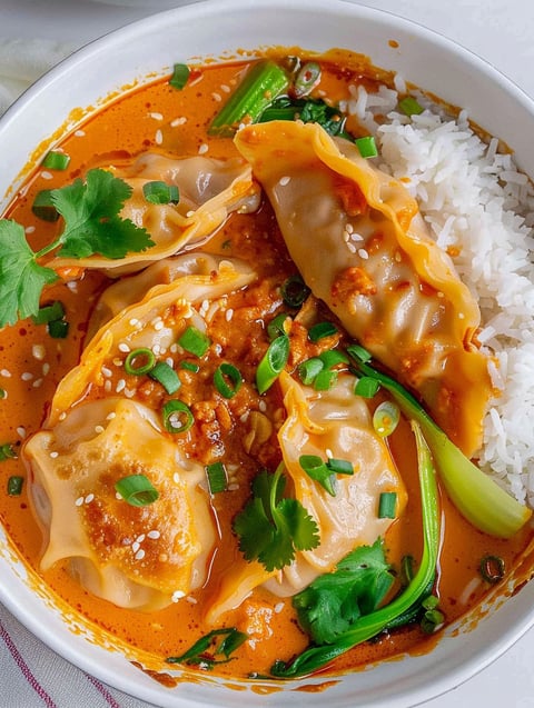 A bowl of food with a dumpling and rice.