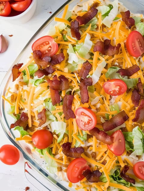 A BLT dip with cheese and tomatoes.